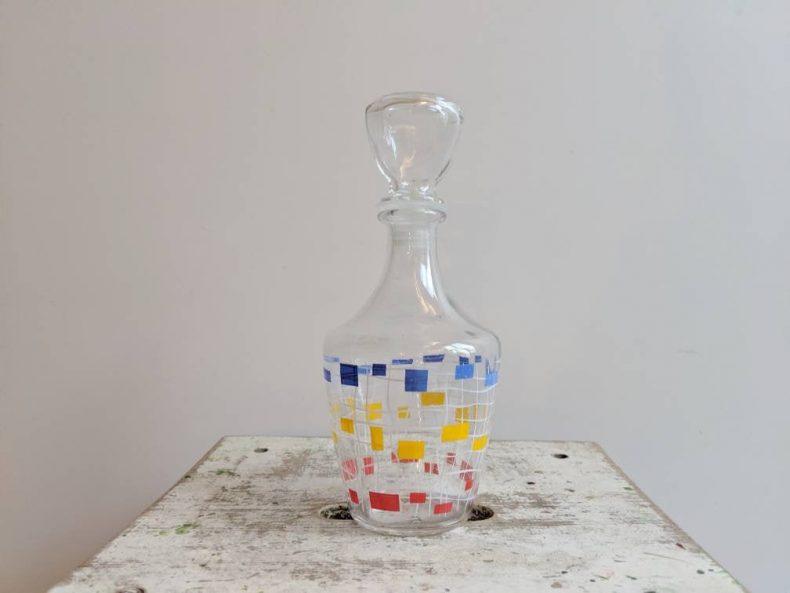 french vintage decanter in red yellow and blue