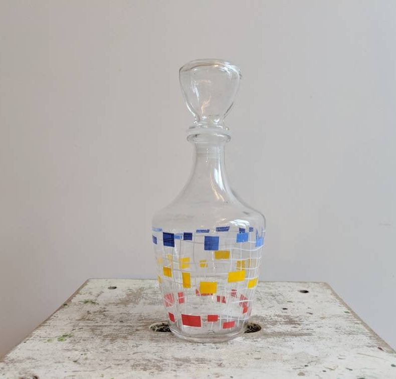 french vintage decanter in red yellow and blue