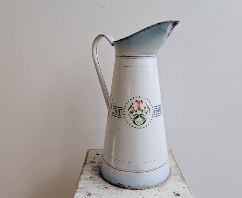 large blue and white enamelware water jug