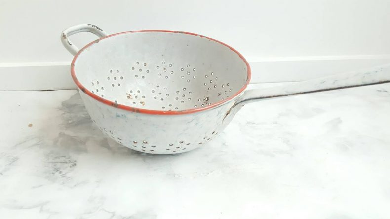 white colander with red trim