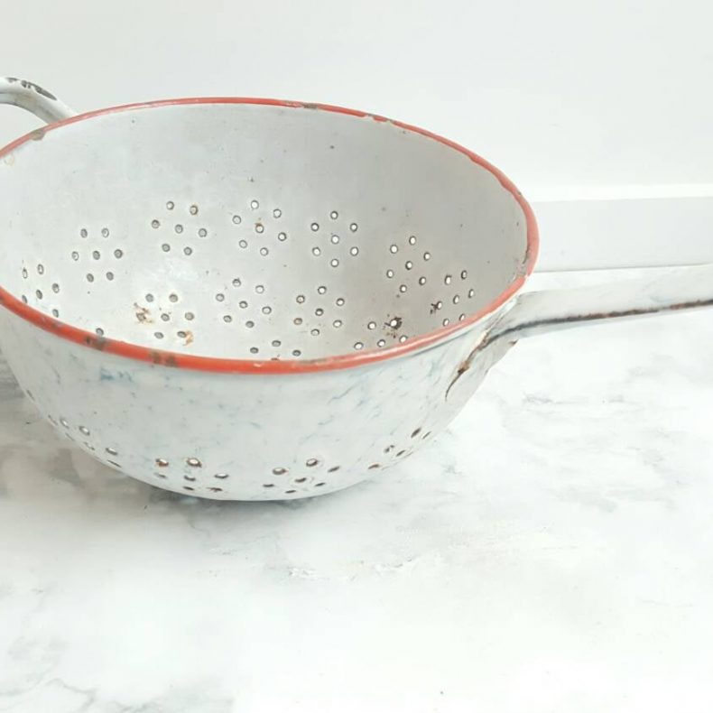white colander with red trim